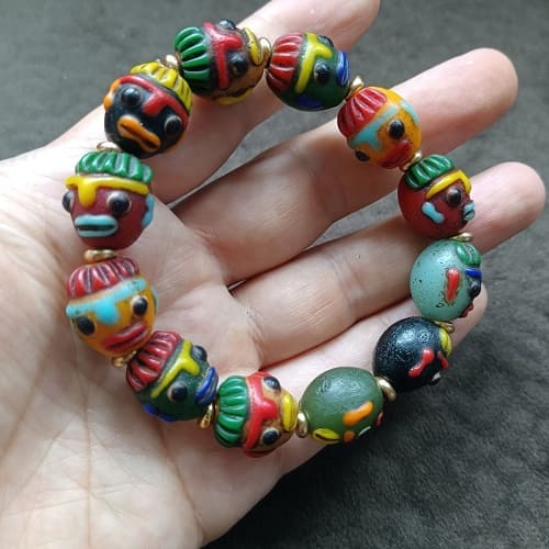 Vintage Tibetan Liuli bracelet with patina and face motif beads