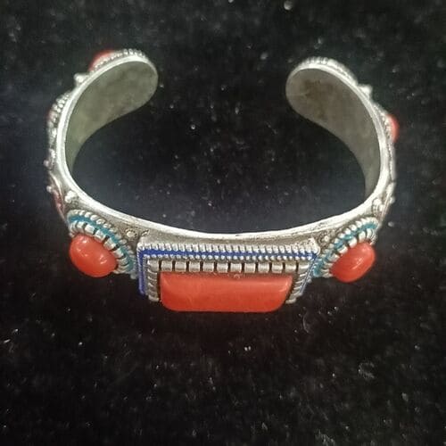 Vintage Tibetan-style cuff bracelet with coral inlay and silver finish, handmade and adjustable