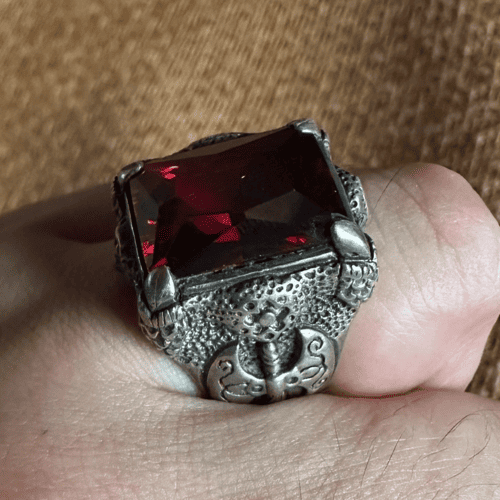 Gothic dragon claw ring with red crystal centerpiece by Xue Lanhua.