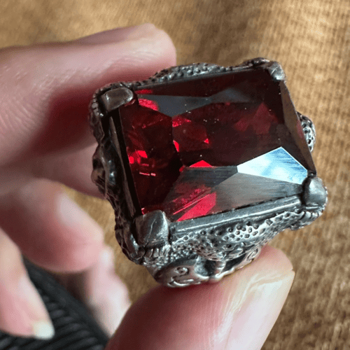 Gothic dragon claw ring with red crystal centerpiece by Xue Lanhua.