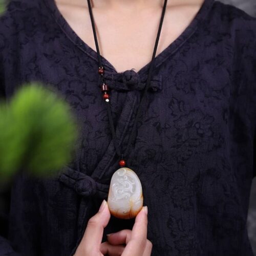 Man wearing Hotan Jade Dragon in the Mansion pendant necklace, illustrating a bold and elegant style.