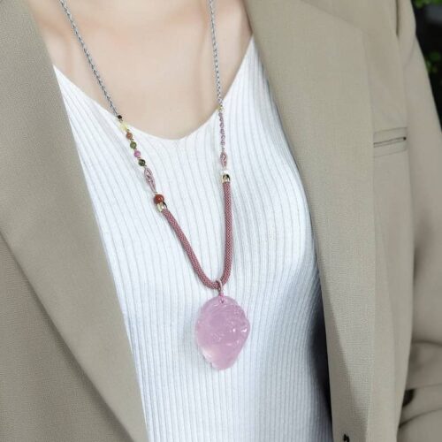 Woman wearing Pink Crystal Golden Toad pendant, illustrating elegant size and charm.