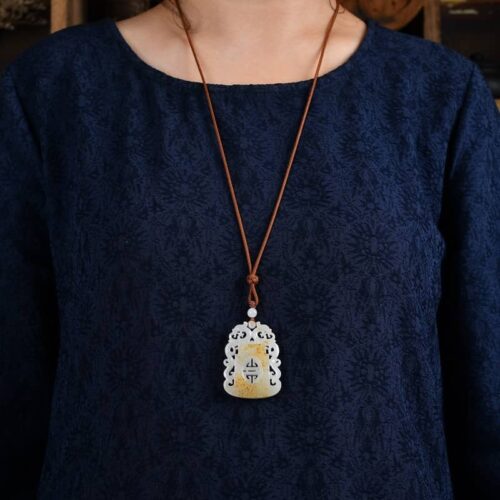 Man wearing Hotan Jade Dragon in the Mansion pendant necklace, illustrating a bold and elegant style.